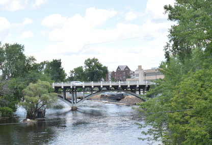 bridge over river with homes in the background